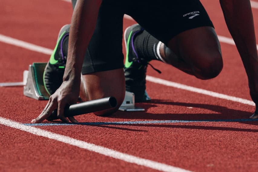 sprinter on starting blocks about to run on track