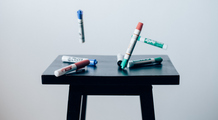 whiteboard-markers-floating-above-table